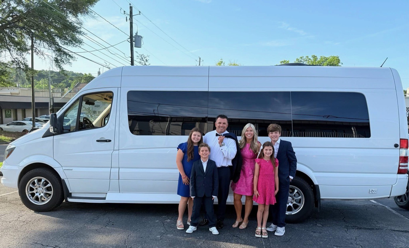 The Vardar family standing with the White Van